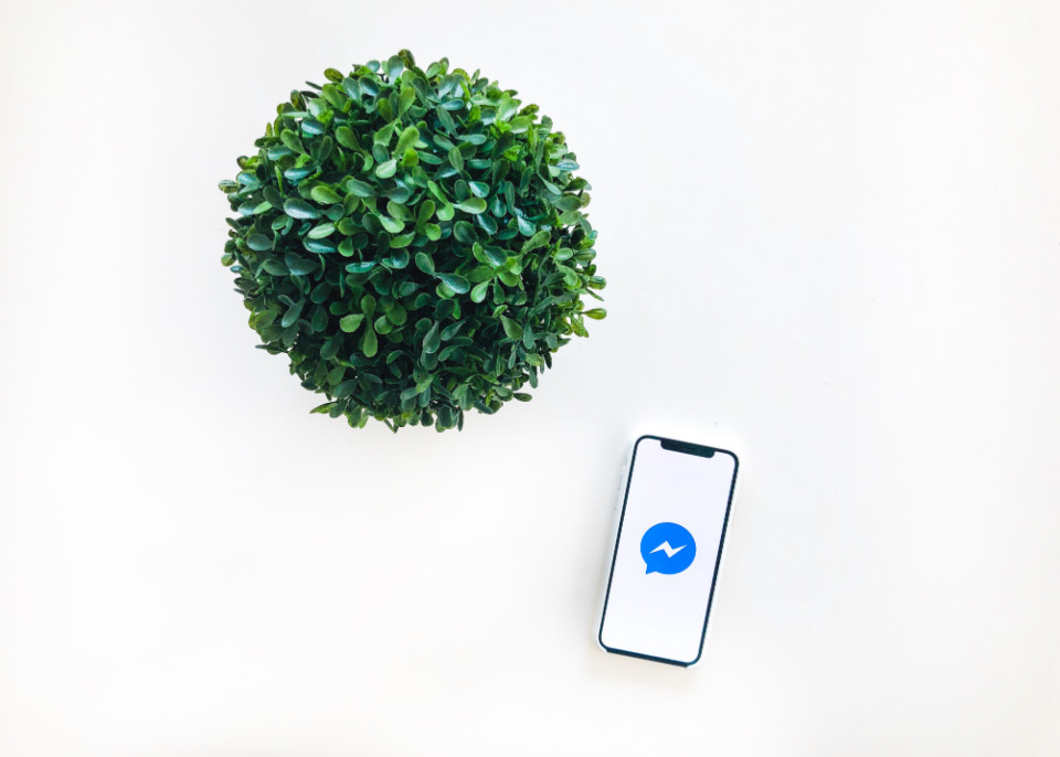 A phone on a desk showing a messaging app